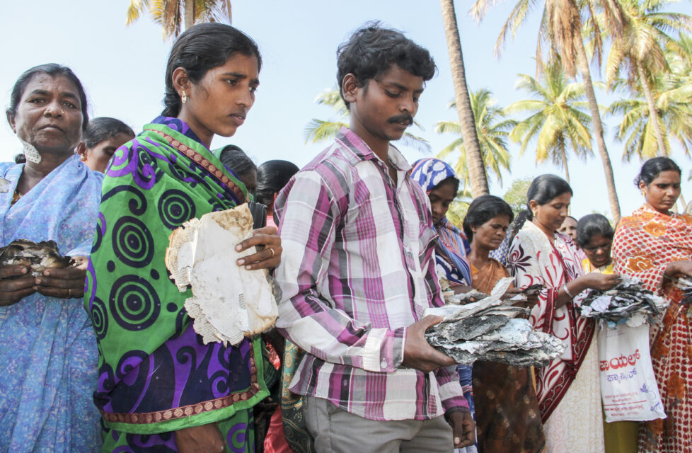 People clutching scraps of burnt Bibles. President's Letter Story.