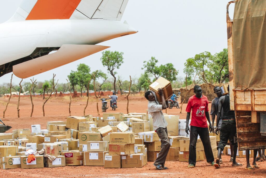 two men loading supplies onto a truck 
